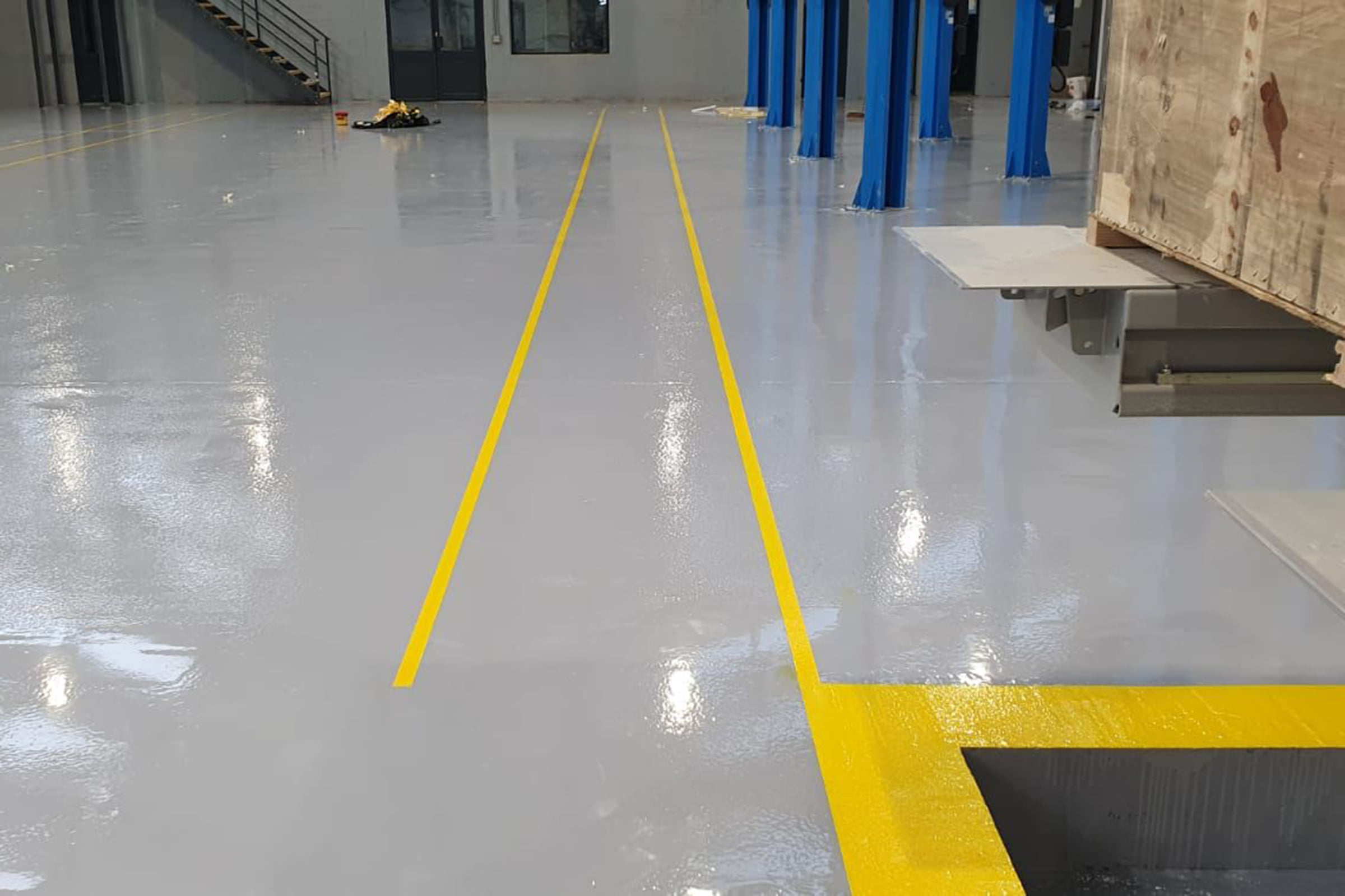 Yellow resin line marking at MOT test centre in Northampton