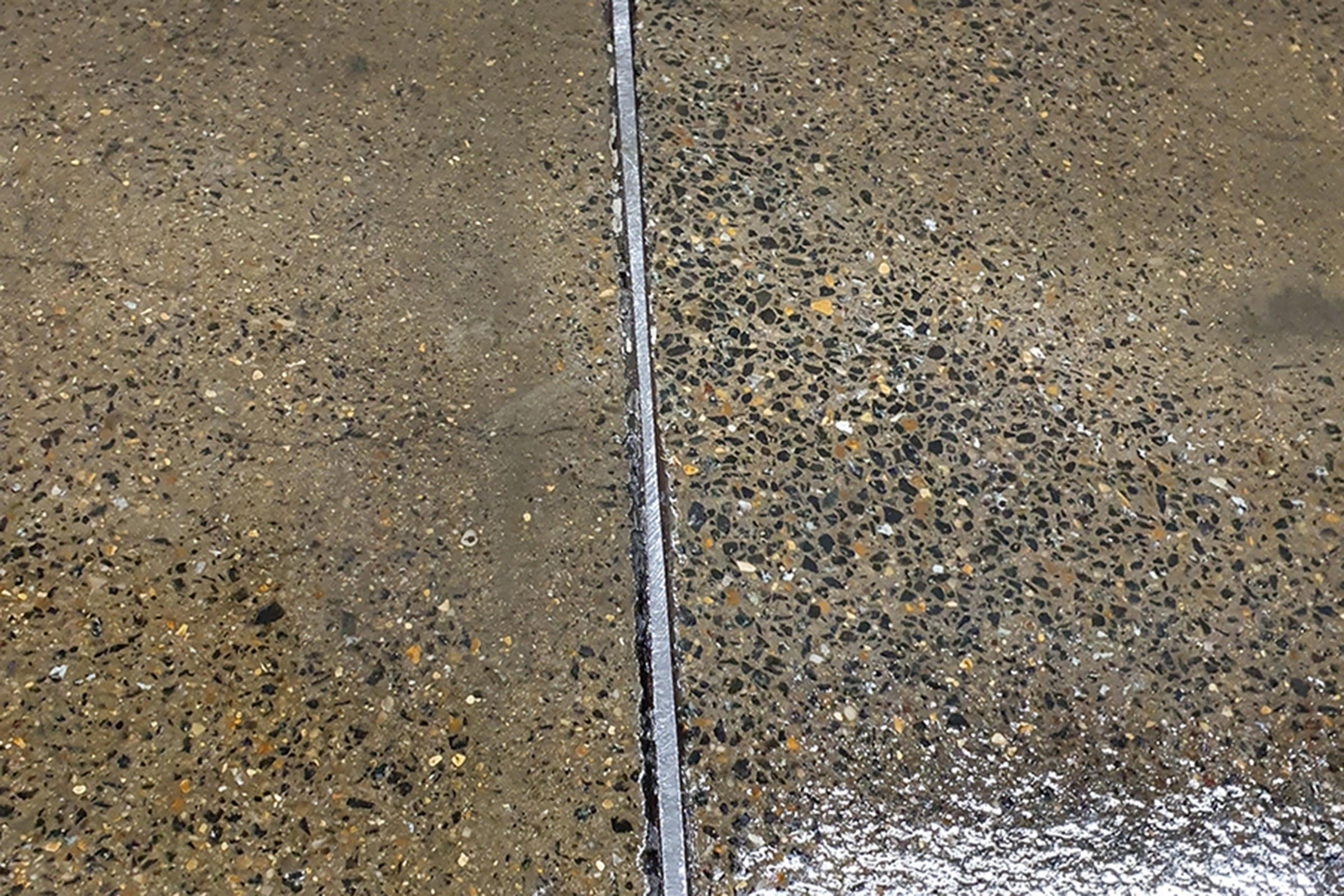 Close up of a warehouse floor, showing section of expansion gap, with flexible epoxy jointing product in situ