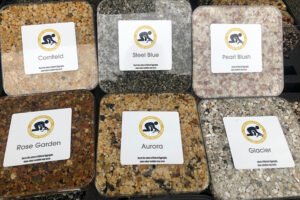 Open resin bound expert display demonstration kit, showing a wide range of aggregate styles and colour options