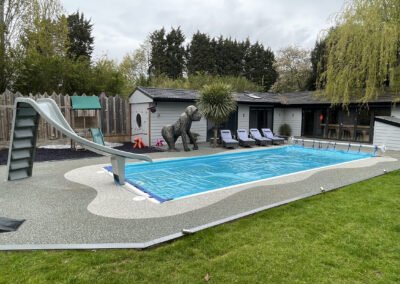 Day time shot of finished resin bound surface, around an outdoor swimming pool in peterborough