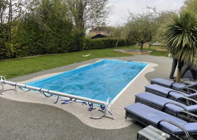 Day time shot of finished resin bound surface, around an outdoor swimming pool in peterborough