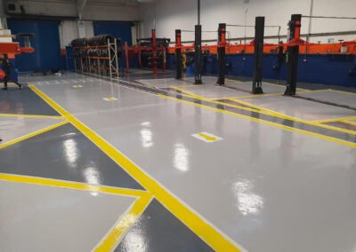 Resin coated floor at an car auto workshop in northampton, showing new line markings, delineating the separate service bays