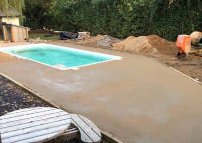 Finished screed around an outdoor swimming pool in peterborough, prior to installation of resin bound surface