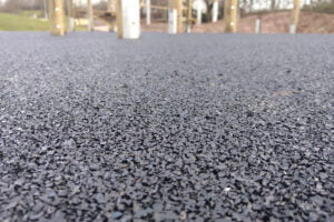 Close up showing finished wet pour rubber surface at an adventure playground in Nottingham