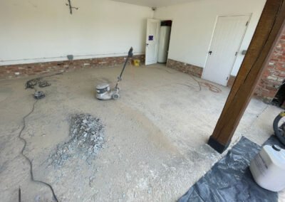 Floor preparation and diamond grinding at a garage, prior to the installation of resin bound surface