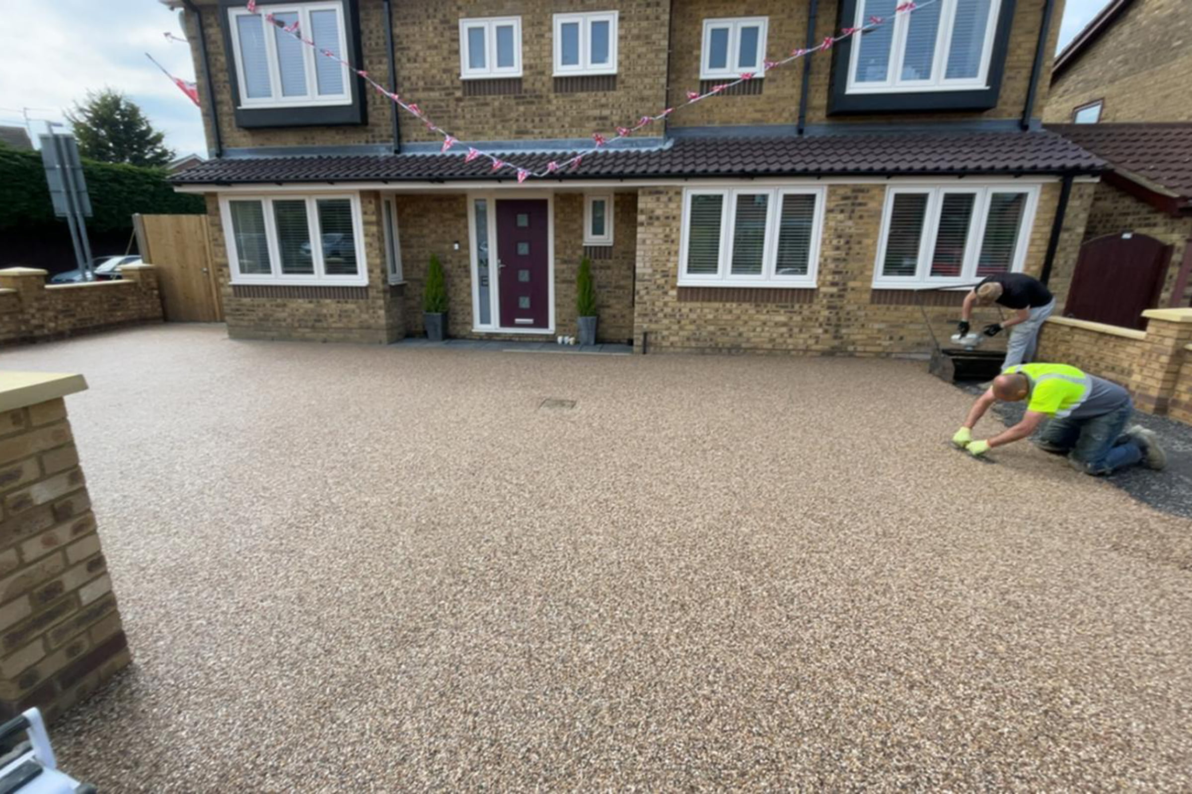 Flooring contractors working on a resin bound driveway in Wellingborough