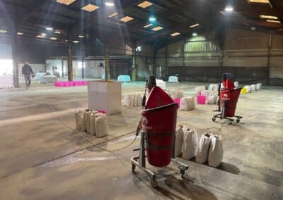 Large factory interior showing floor screed materials ready for use and portamix mixers
