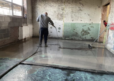 Floor screed contractor installing self levelling compound