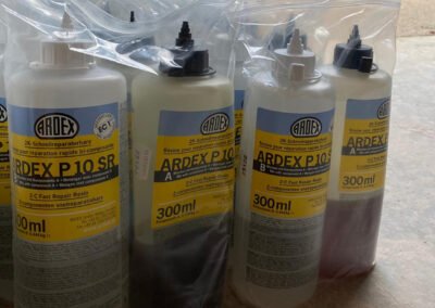 Bottles of ardex p10 sr, fast repair resin waiting to be used