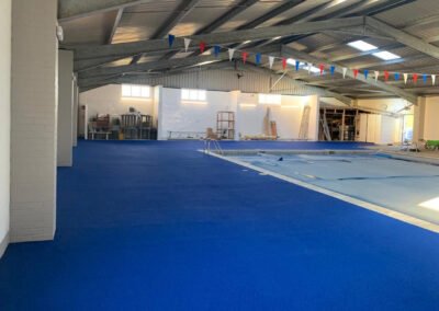 Blue rubber crumb surface installation at an indoor swimming pool california sands oasis pool, great yarmouth