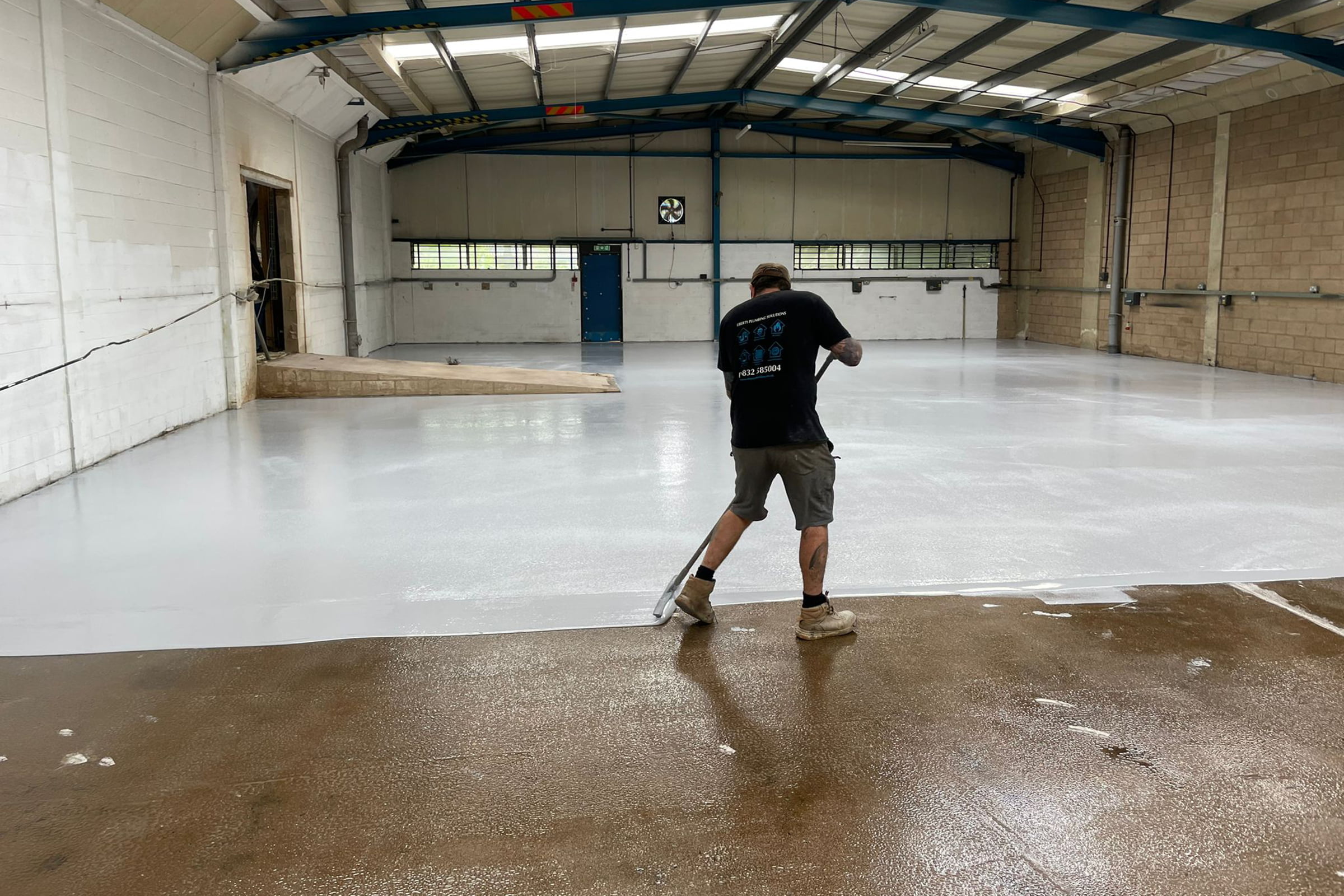 Epoxy resin floor being installed in a warehouse