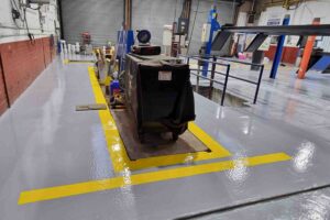 Epoxy resin line marking in northampton Completed yellow epoxy line marking at a car garage in northampton