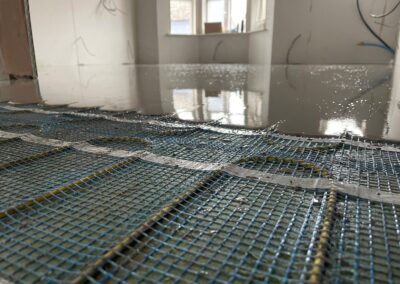 Flow screed being installed on thermosphere underfloor heating mesh