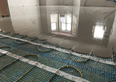 Flow screed being installed on thermosphere underfloor heating mesh