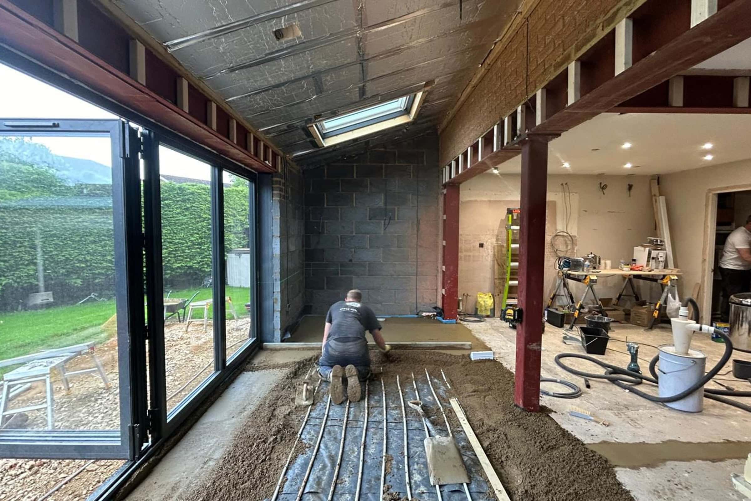 Floor screeding contractor working on underfloor heating screed project