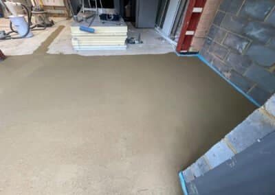 Partially complete underfloor heating screed installation