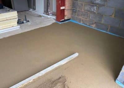 Partially complete underfloor heating screed installation