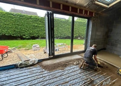 Floor screeding contractor working on underfloor heating screed project