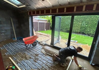 Floor screeding contractor working on underfloor heating screed project