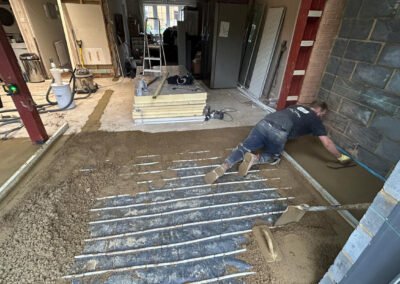 Floor screeding contractor working on underfloor heating screed project
