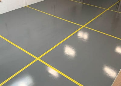 Taped expansion gaps on a warehouse floor