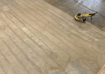 Diamond grinder machine used to prepare a concrete floor for a resin coating