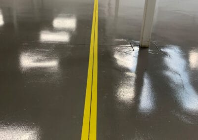 Taped expansion gaps on a warehouse floor