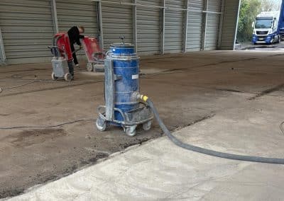 Floor grinding equipment in a warehouse space