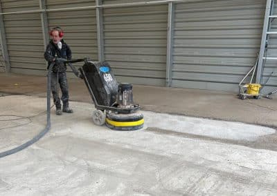 Man operating floor grinding machine