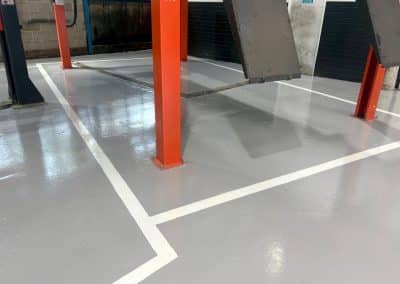 Clean, epoxy resin floor in an automotive workshop with line markings