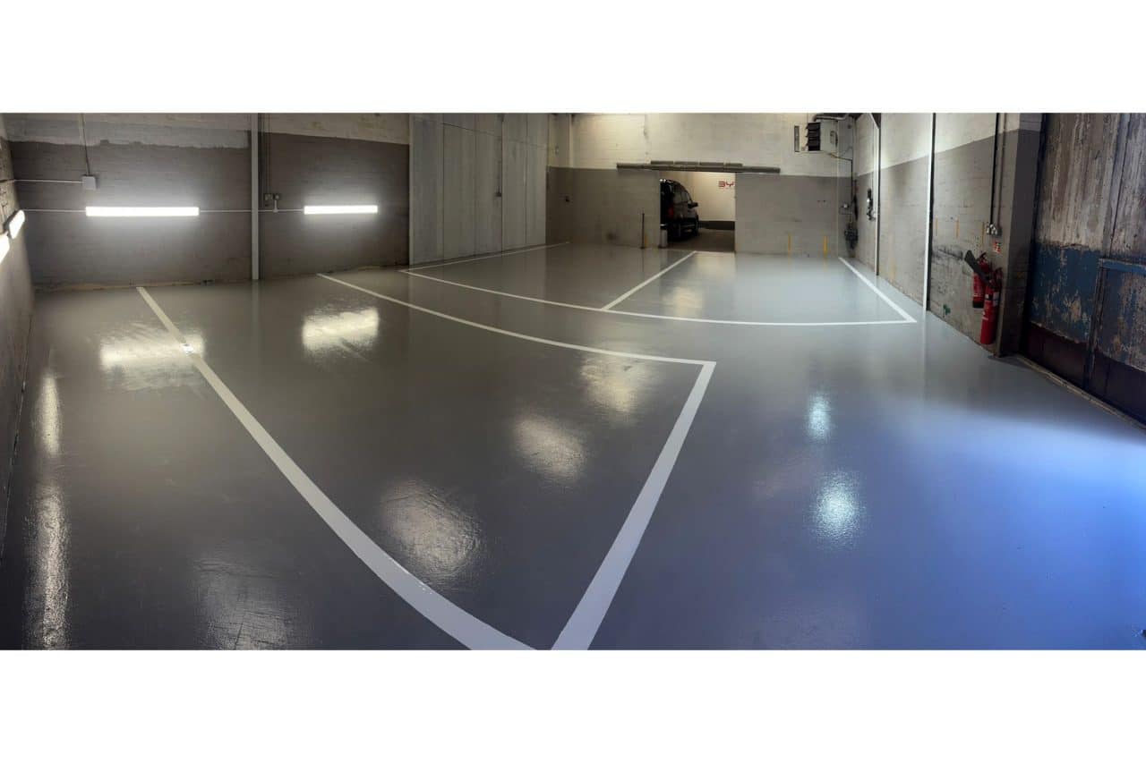 New mid grey epoxy resin flooring, with line markings, at automotive workshop
