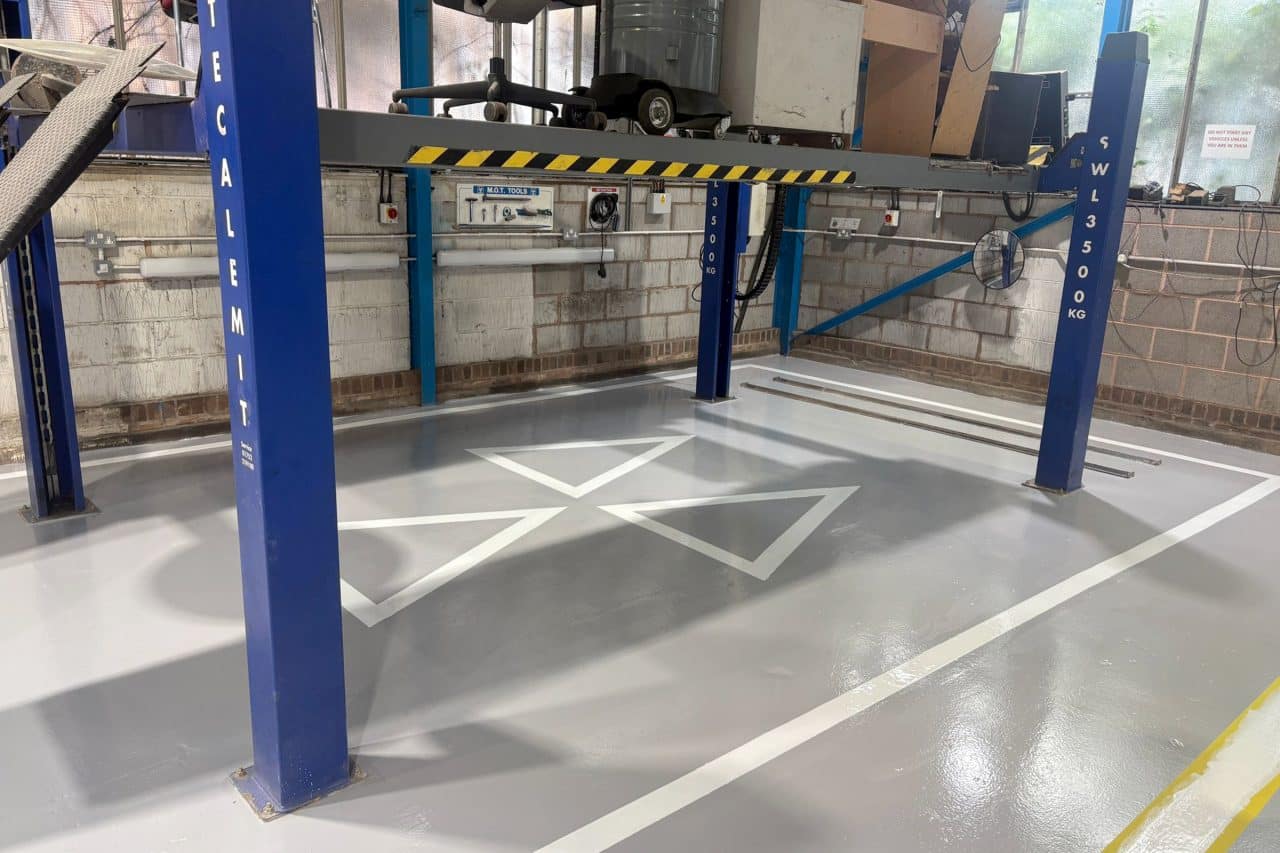 Clean epoxy resin workshop floor with MOT line markings