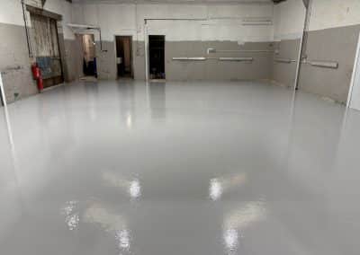 New mid grey epoxy resin flooring at automotive workshop