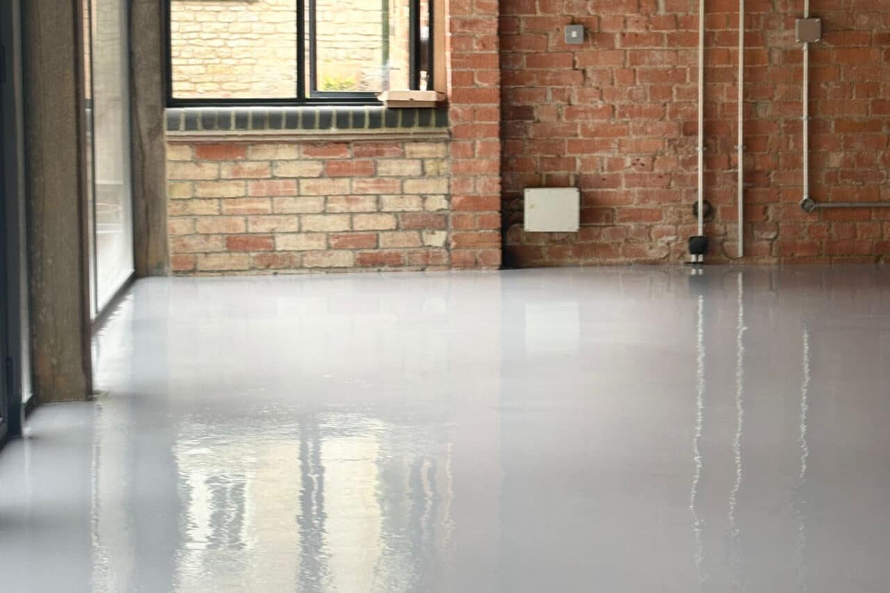 Freshly installed yellow and black resin line marking at an mot test centre in northampton.