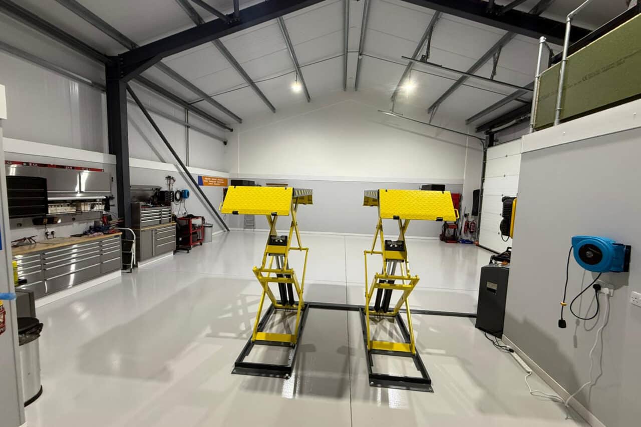 Freshly installed yellow and black resin line marking at an mot test centre in northampton.