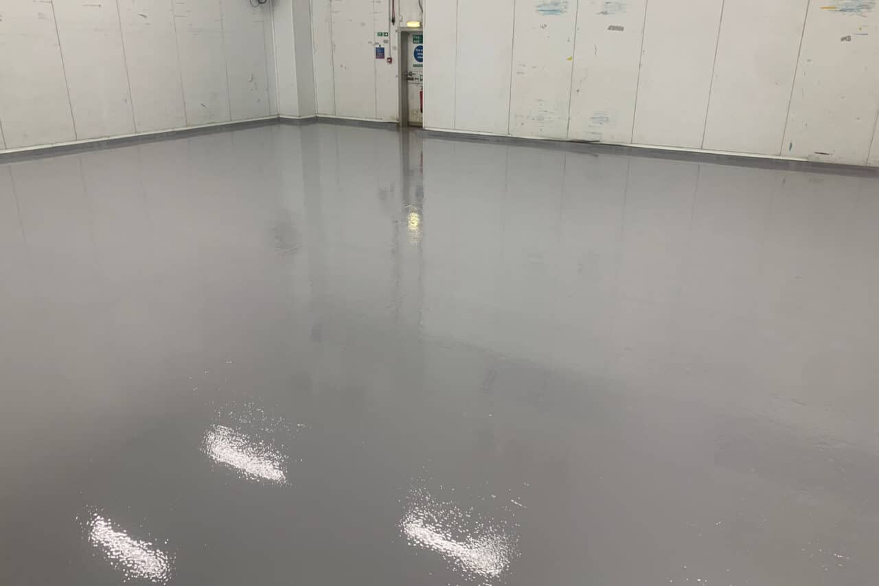 Freshly installed yellow and black resin line marking at an mot test centre in northampton.