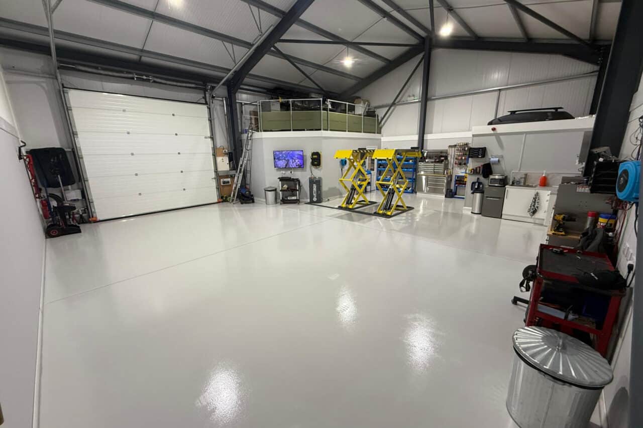 Freshly installed yellow and black resin line marking at an mot test centre in northampton.