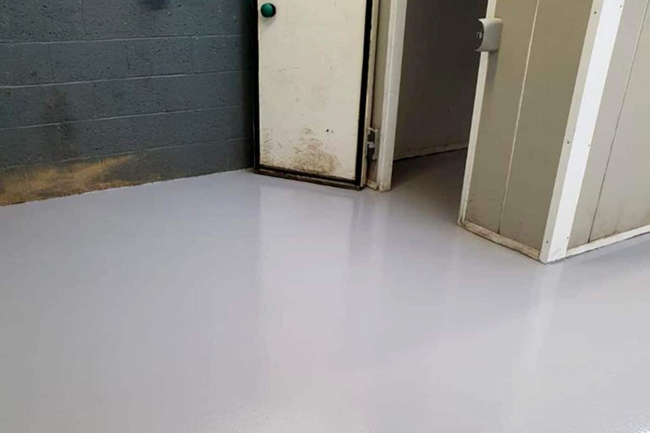 Grey epoxy resin flooring in the storage area of a commercial kitchen